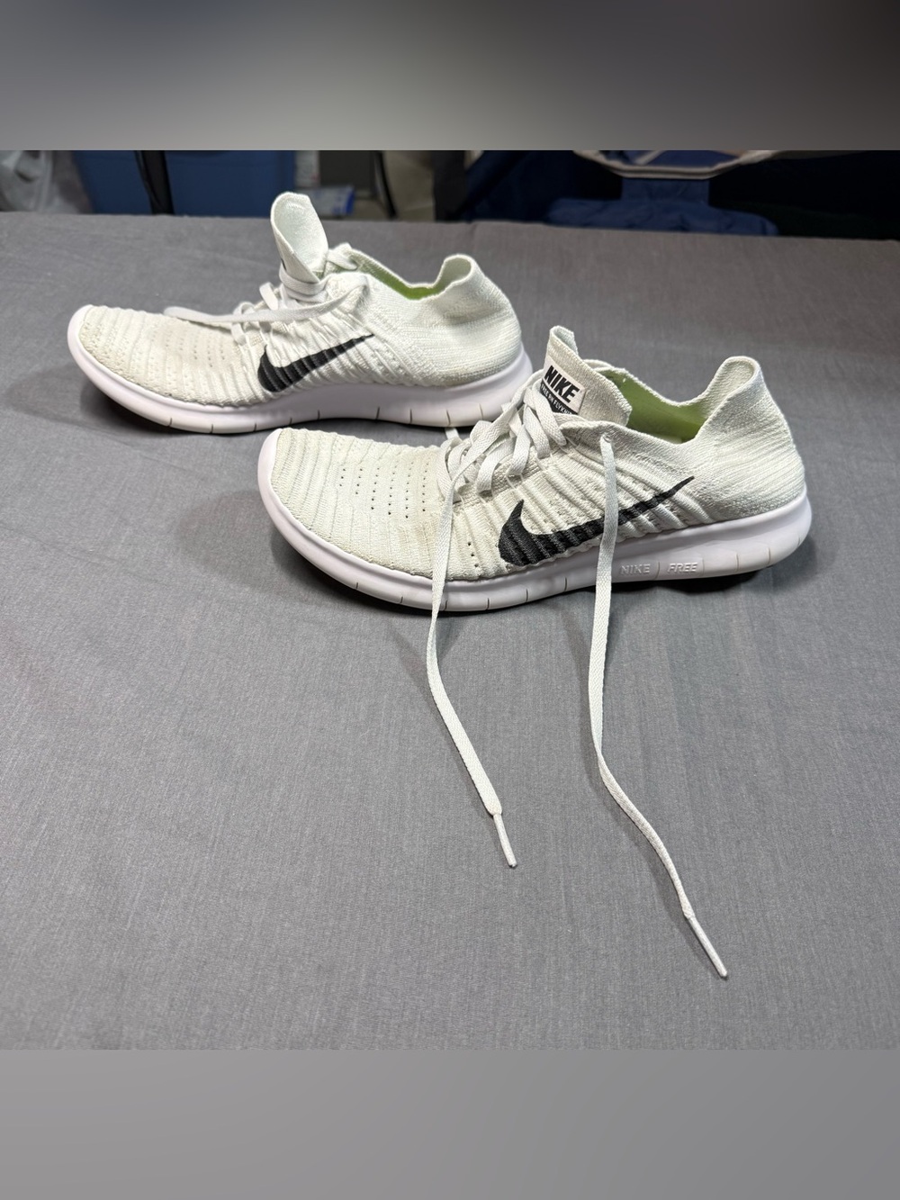 Nike Men’s White Flyknit Athletic Shoes with Black Swoosh